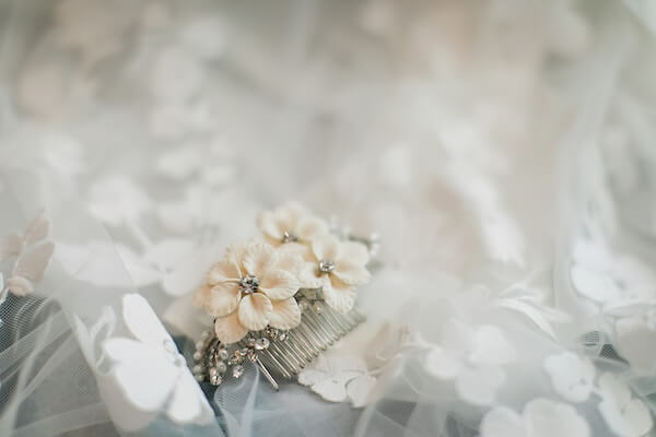 A bride's wedding veil and hair clip.