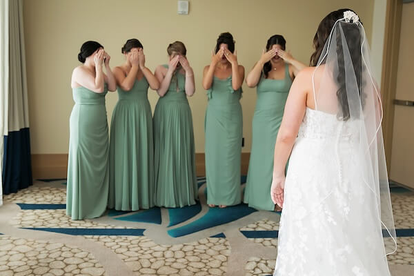 The bridal party is getting ready to see the bride for the first time.