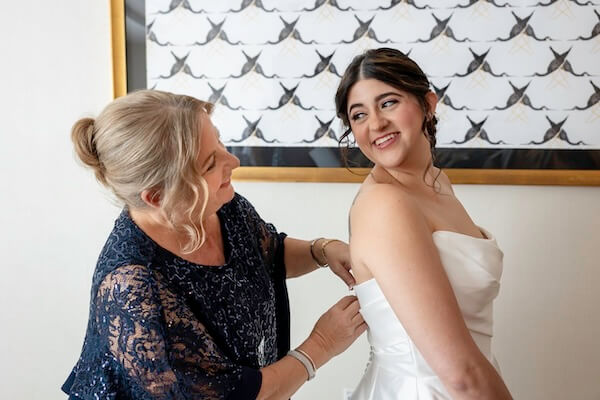 A Clearwater bride's mom helping her dress.