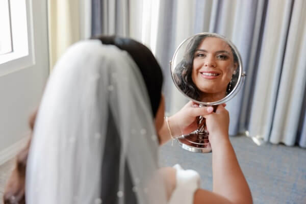 A bride looking in the mirror.