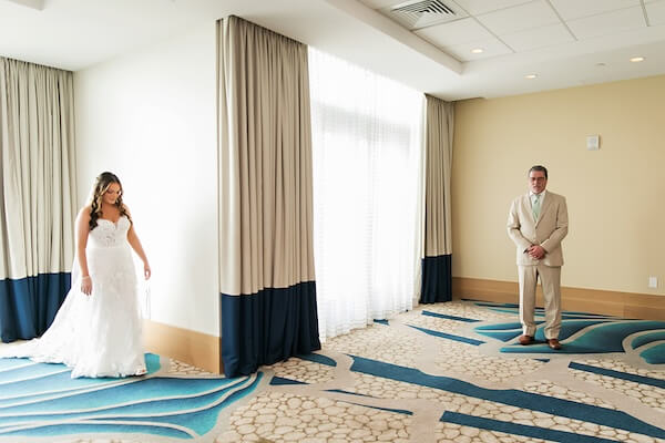 Father of the bride sees his daughter before her Wyndham Grand wedding.