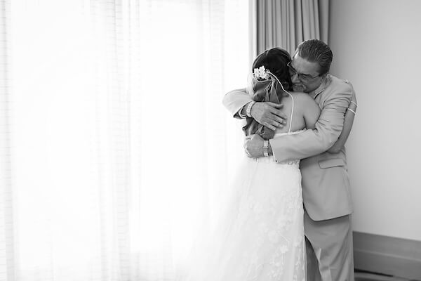 Father of the bride sees his daughter before her Wyndham Grand wedding.
