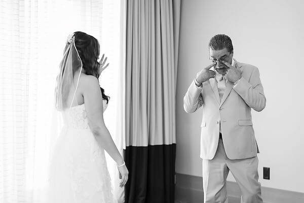 Father of the bride sees his daughter before her Wyndham Grand wedding.