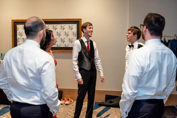 A grtoom and his wedding party getting ready for the big day.