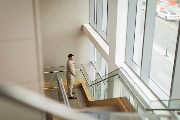 The groom is waiting to see his bride for the first time before their Wyndham Grand wedding in Clearwater, Florida.