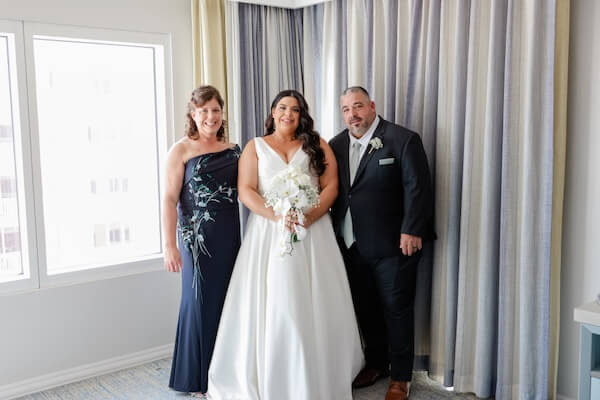 A bride with her mom and dad just beofre her Sky Terrace weding ceremony.