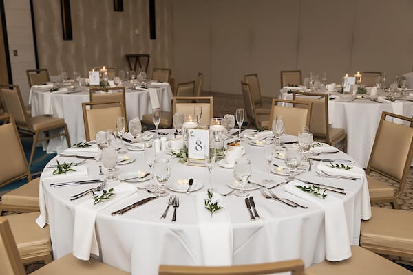 Tables are set for a Wyndham Grand wedding reception in Clearwater Beach, Florida.