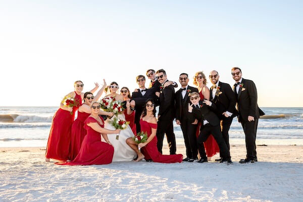 A newlywed couple and their wedding party are having some fun on Clearwater Beach.