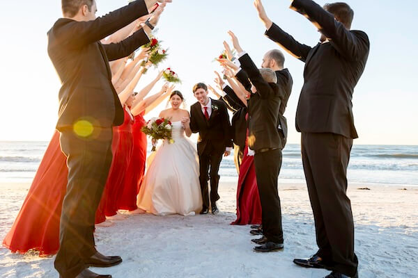 A newlywed couple and their wedding party are having some fun on Clearwater Beach.