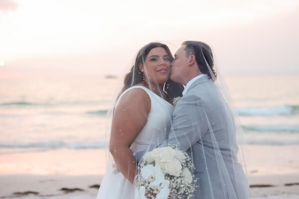Newlyweds on Clearwater Beach at sunset.