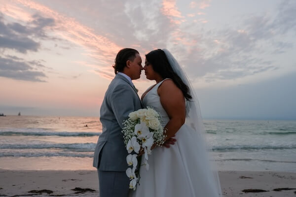Newlyweds on Clearwater Beach at sunset.