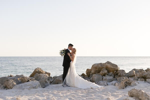 Bride and groom on Clearwater Beach after their Opal Sands Resort wedding.