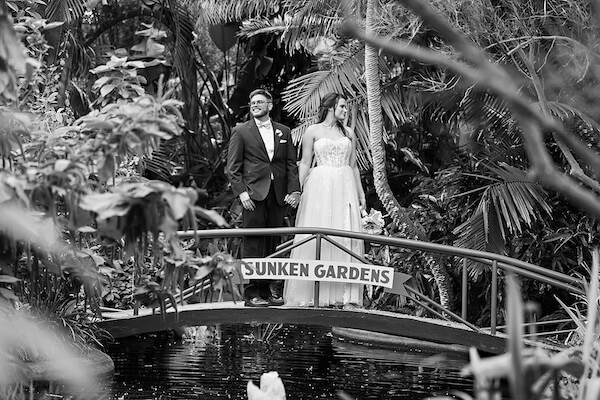 Black and white portrait of a newlywed couple at Sunken Gardens in St. Petersburg, Florida.