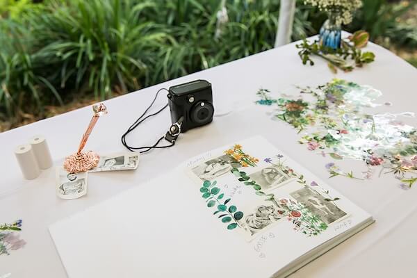 Polaroid camera and photos for a wedding guest book.