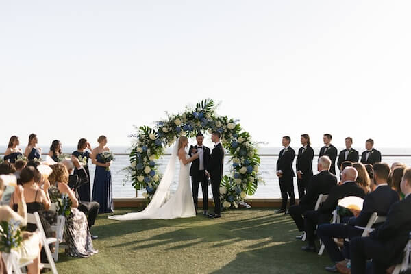 The wedding ceremony was held on the event lawn of the Opal Sands Resort.