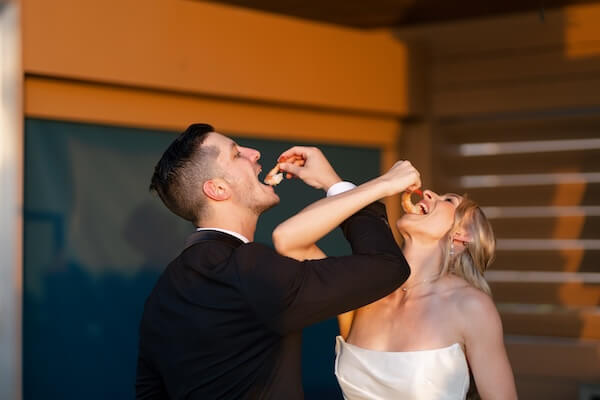 A newlywed couple toasting with Jumbo Shrimp at their Clearwater Beach, Florida wedding!