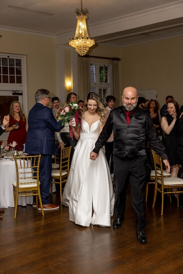 A bride and groom aming their grand entrance at thier Tampa Bay wedding.