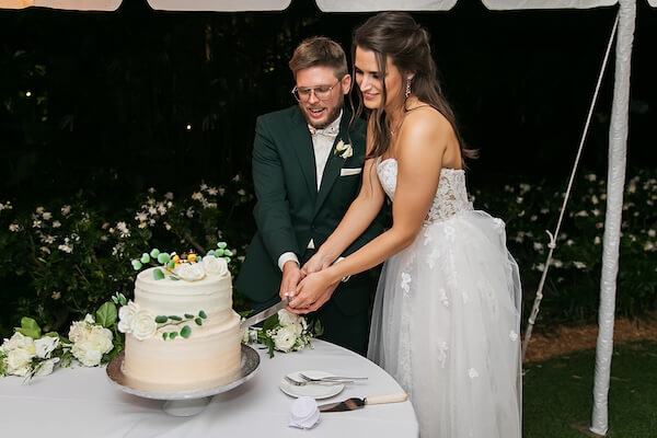 Bride and groom cutting their wedding cake.