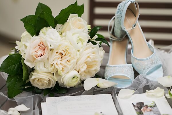 A flat lay photograph of a bride's wedding day accessories.