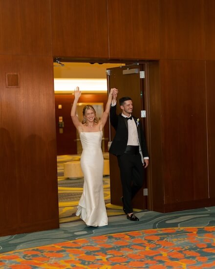 A newlywed couple making their grand entance at their Opal Sands Resort wedding reception.