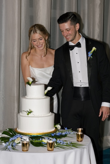 A bride and groom cutting their wedding cake.