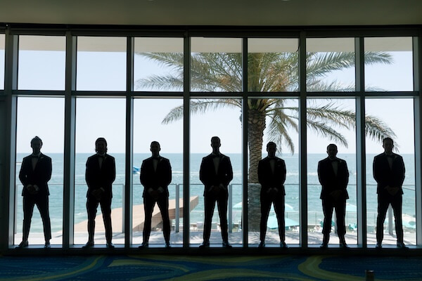 A groom and groomsmen looking at Clearwater Beach from the Opal Sands Resort.