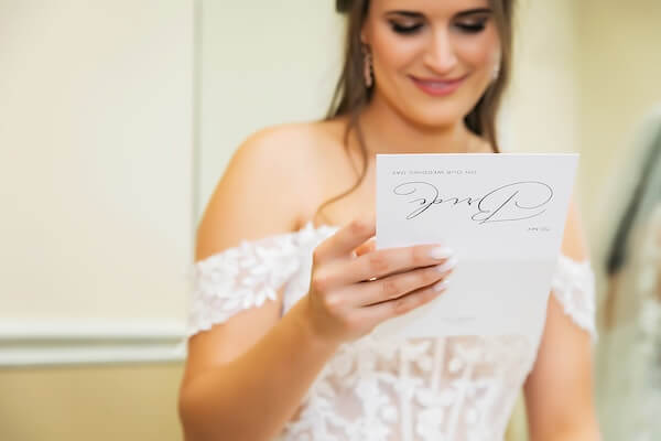 A bride reading a note from her groom-to-be.