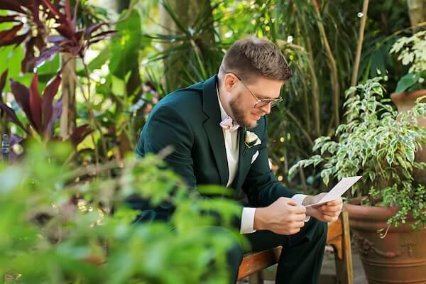 A groom reading a note from his bride-to-be at Sunken Gardens in St. Petersburg, Florida.