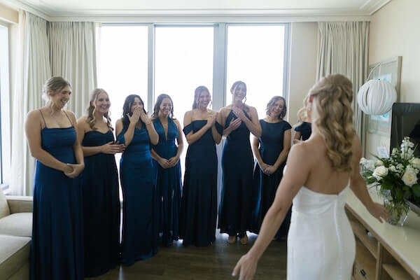 The bridesmaids seeing the bride for the first time beofre her first look with the groom.