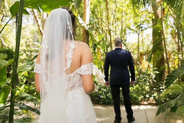 A bride and her father's first look on her wedding day at Sunken Gardens in St. Petersburg, Florida.