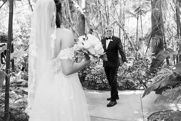 A bride and her father's first look on her wedding day at Sunken Gardens in St. Petersburg, Florida.