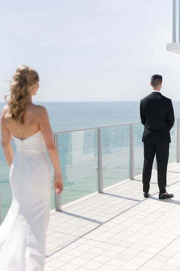 A bride and groom's first look before their wedding at the Opal Sands Resort.