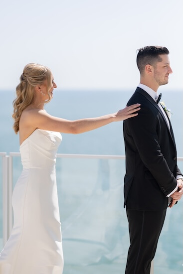 A bride and groom's first look before their wedding at the Opal Sands Resort.