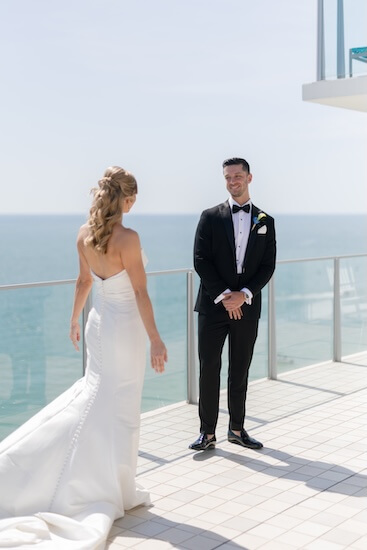 A bride and groom's first look before their wedding at the Opal Sands Resort.