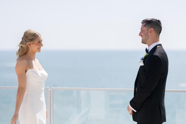 A bride and groom's first look before their wedding at the Opal Sands Resort.
