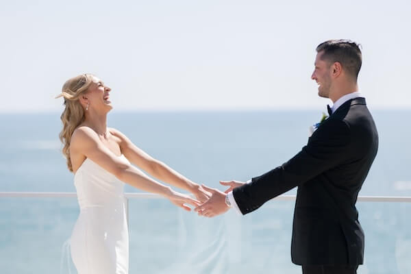 A bride and groom's first look before their wedding at the Opal Sands Resort.