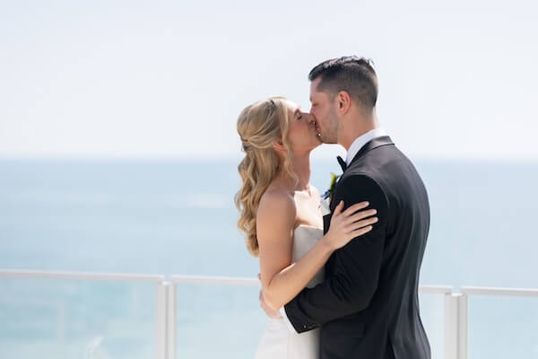 A bride and groom's first look before their wedding at the Opal Sands Resort.