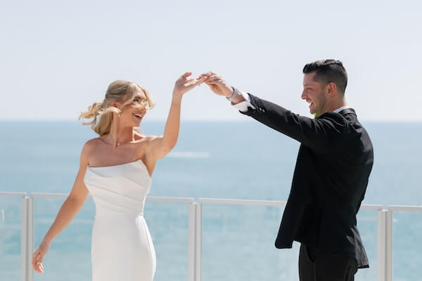 A bride and groom's first look before their wedding at the Opal Sands Resort.