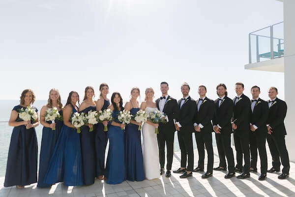 A bride and groom with their wedding party at the Opal Sands Resort.