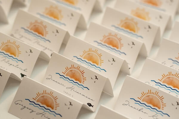 Custom escort cards with a beautiful sunset motif for a St. Pete wedding reception at the Mahaffey Theater.