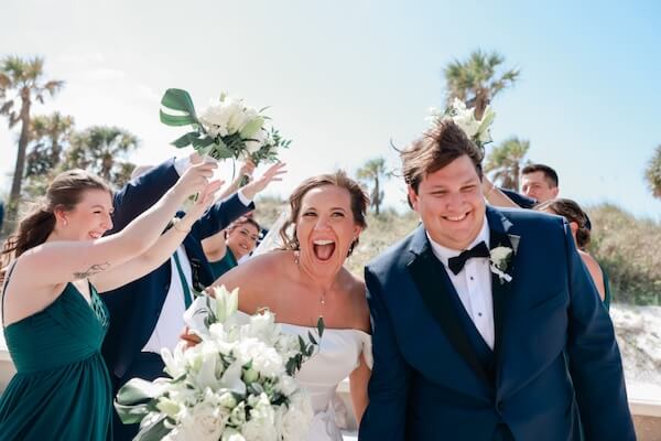 A bride and groom having fun with their wedding party before their Clearwater Beach wedding.