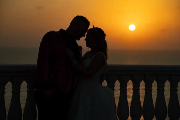 Bride and groom enjoying a sunset overlooking the Gulf of Mexico