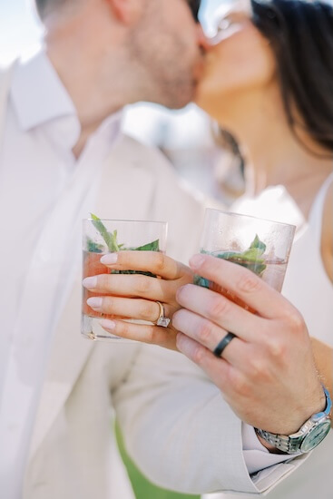 A bride and groom enjoying a Signature Cocktail at the Sandpearl Resort wedding reception.