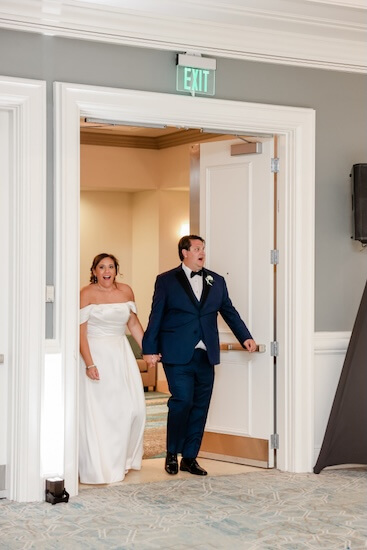 The bride and groom take a sneak peek at their Clearwater Beach wedding reception.