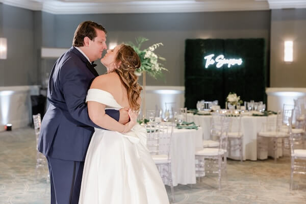 The bride and groom take a sneak peek at their Clearwater Beach wedding reception.