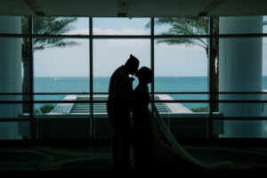 A bride and groom enjoying the blue waters of the Gulf of Mexico