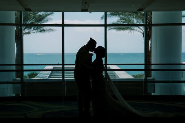 A bride and groom enjoying the blue waters of the Gulf of Mexico