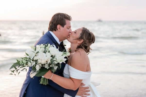 A bride and groom enjoying golden hour on Clearwater Beach.