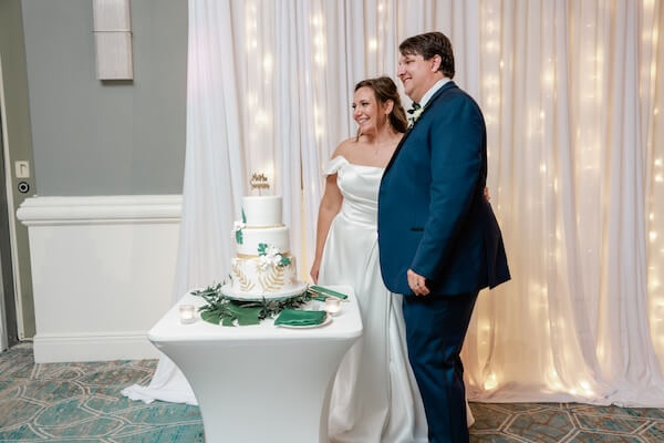 A bride and groom cutting their wedding cake.