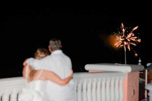 A bride and groom enjoying fireworks near Clearwater Beach.